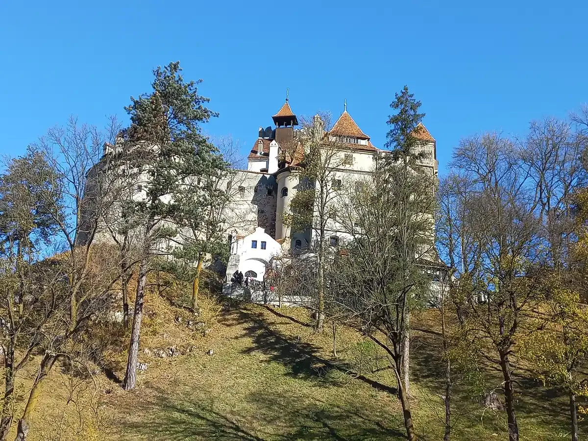 Bran Castle among autumn trees in October, the month of Bran Castle Halloween