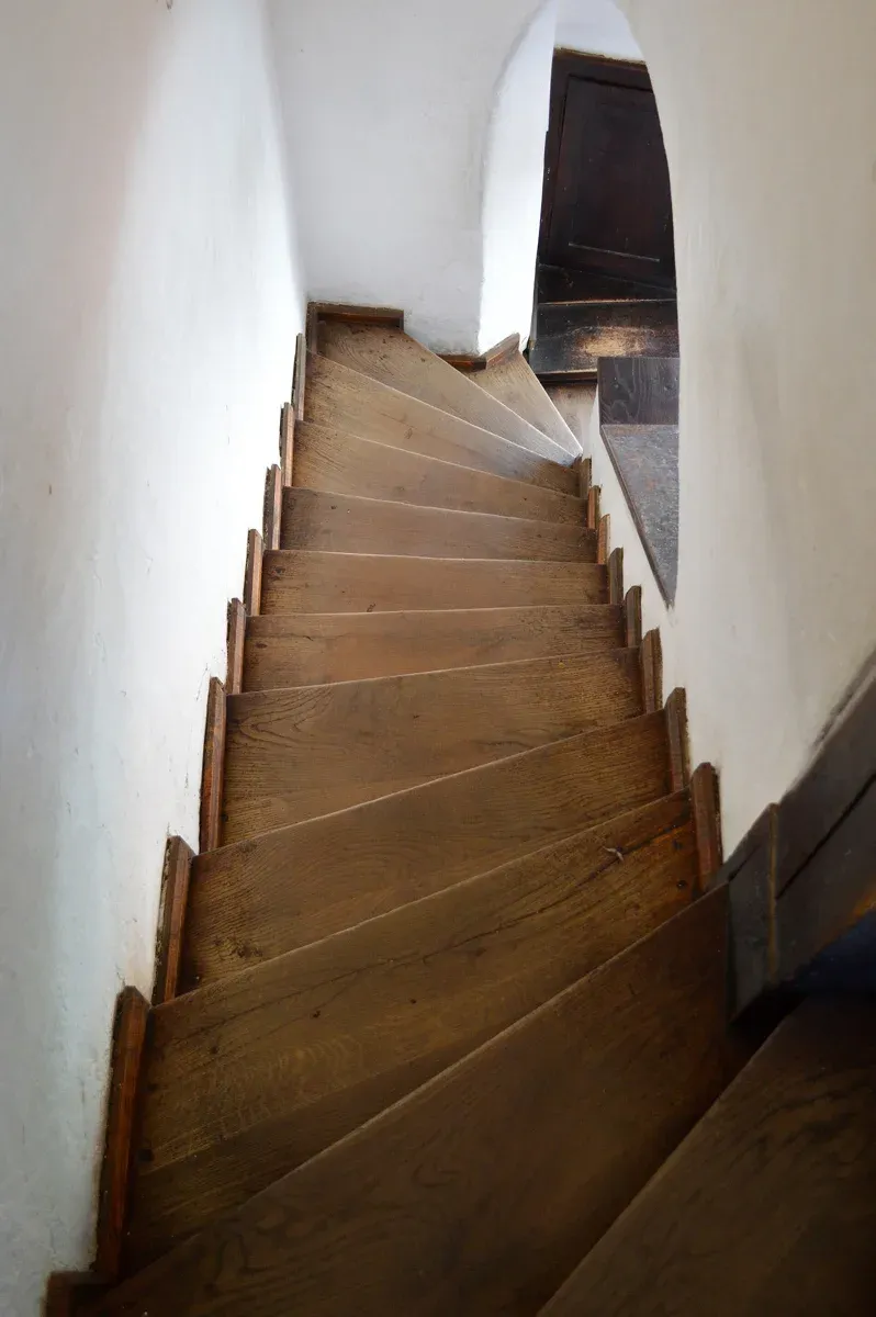 Narrow wooden stairs inside Bran Castle, worth knowing before you buy Bran Castle tickets